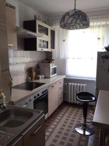 a small kitchen with a sink and a stove at Lake view apartment Mragowo in Mrągowo