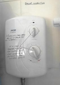 a white toilet with writing on the side of it at 78 Florida Holiday Park in Hemsby +7 photos