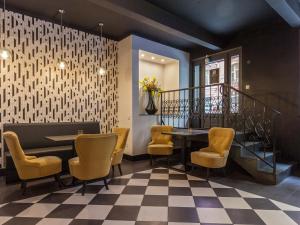 a restaurant with a table and chairs and a staircase at Golden Prague Rooms in Prague