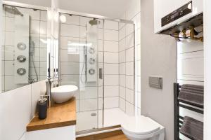 La salle de bains est pourvue d'une douche, de toilettes et d'un lavabo. dans l'établissement Toress Apartamenty Deptak, à Szczecin