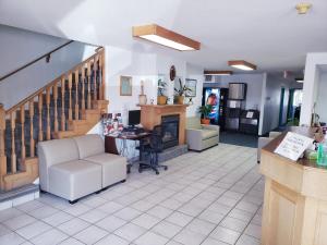 a living room with a desk and a staircase at Travel-Inn Resort & Campground in Saskatoon