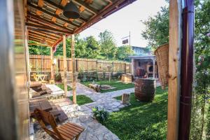 a backyard with a wooden pergola and a patio at BUKHRIANI in Kutaisi