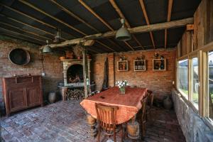 a dining room with a table and a brick wall at BUKHRIANI in Kutaisi