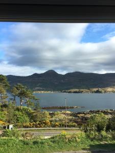a view of a lake with mountains in the background at Lochalsh View, Kyle, 1 Mile to Skye in Kyle of Lochalsh