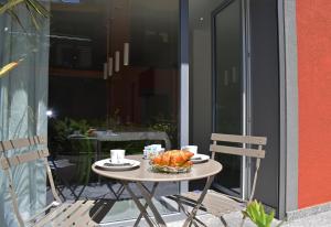 a table with a basket of food on it on a patio at Residence Lake Como in Colico