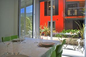 a table with glasses and plates on it on a patio at Residence Lake Como in Colico
