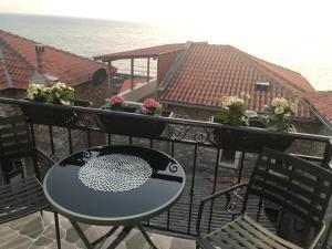 a balcony with a table and chairs and the ocean at Apartments Debora in Ulcinj