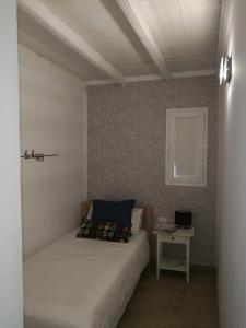 a small bedroom with a bed and a table at Gaviota in Caleta De Fuste +22 photos