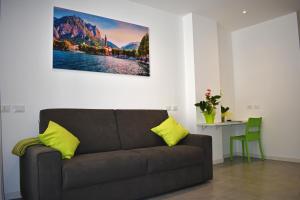 a living room with a couch and a table at Residence Lake Como in Colico