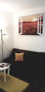 a living room with a couch and a picture on the wall at Hotel Am Fleesensee in Malchow