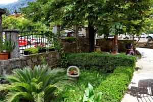 a garden with a fence and some plants and flowers at Apartments Martiva in Kotor
