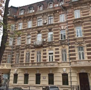 a large building with many windows on a street at Welcome Apartments in Odessa in Odesa