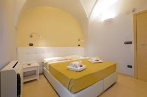 una camera da letto con un letto e asciugamani di Villa Flem Luxury by HDSalento a Montesano Salentino