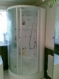 a shower with a glass enclosure in a bathroom at Comfy Room Well Located in Crystal Palace
