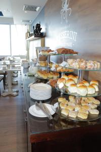 a buffet line with different types of pastries and pies at Sol Ipanema Hotel in Rio de Janeiro