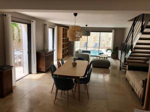 a living room with a table and chairs and a couch at ARCHE DE PEZENAS in Pézenas