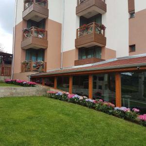 a large building with flowers in front of it at Lakata Guest House in Zasele