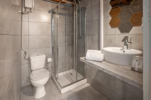 a bathroom with a shower and a toilet and a sink at Urban Suites in Aveiro +90 photos