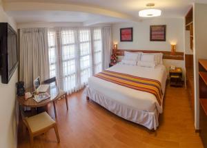 Postel nebo postele na pokoji v ubytování Taypikala Hotel Cusco