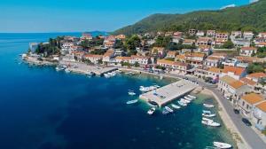 an aerial view of a small town with boats in the water at Apartments Pecotić in Brna
