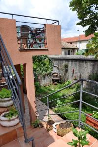 a view of a house with a balcony and a garden at Apartments Martiva in Kotor