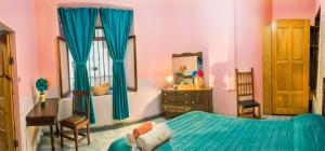 Ένα ή περισσότερα κρεβάτια σε δωμάτιο στο Casa Lupita Hostel