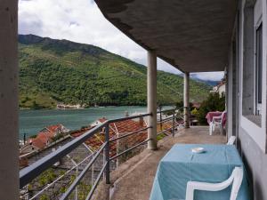 a balcony with a table and a view of a river at Apartments Eftimov in Tivat +10 photos