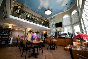 a restaurant with tables and chairs in a room at DeSoto Beach Hotel in Tybee Island