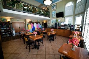 ein Restaurant mit Tischen und Stühlen in einem Zimmer in der Unterkunft DeSoto Beach Hotel in Tybee Island