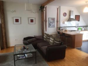 a living room with a couch and a kitchen at Chalet Bovec in Bovec