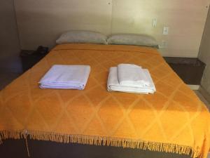 a bed with two towels on top of it at Hotel Suipacha in San Miguel de Tucumán