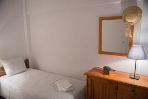 A bed or beds in a room at ILIOCHARI sea view apartments Oropos - Kalamos