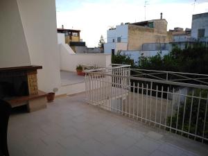 a balcony of a building with a fireplace at Josephine Holidays in Lecce