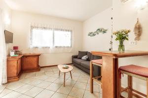 a living room with a couch and a table at Casa vacanze Lungomare in Santa Maria Navarrese