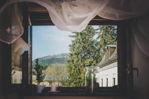 a window with a view of a building at Dworek Karłów in Karłów