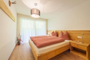 a bedroom with a large bed and a window at Chalet Martin in Valdaora