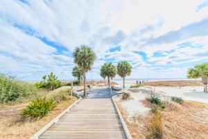 a wooden path to the beach with palm trees at Saint Andrews Common 1774 in Hilton Head Island +26 photos
