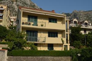 an apartment building in front of a mountain at Apartments Kordić in Kotor