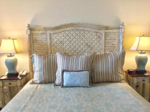 a bed with a white comforter and pillows at Oceano Hotel and Spa Half Moon Bay Harbor in Half Moon Bay