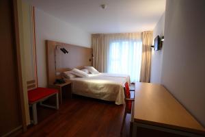 Un pat sau paturi într-o cameră la Hotel Ril