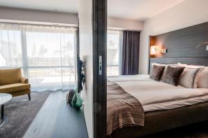 Säng eller sängar i ett rum på Hotel Riviera Strand