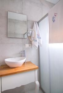 bagno con lavandino bianco e specchio di Le Vent Alaçatı Otel a Smirne