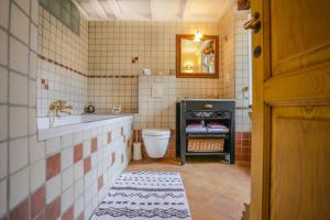 a bathroom with a sink and a toilet and a mirror at Latu Corsu - Côté Corse - Gites et chambres d'hôtes au Cap Corse in Ersa +98 photos