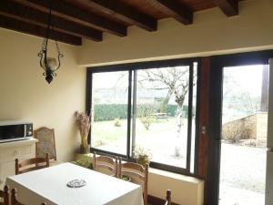 a dining room with a table and a large window at chez gallon chambres d’hôtes in Vézac