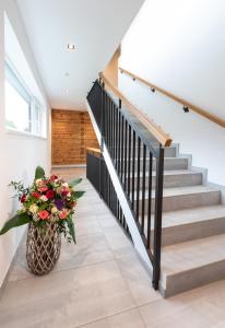 a staircase with a vase of flowers on the floor at ImPuls | aparts in Schladming