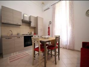 a kitchen with a table and chairs in a kitchen at Casa Antica in Cassibile