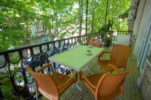 a table and chairs sitting on a balcony at HOTEL VENETO in Kutaisi