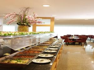 a buffet line with plates of food in a restaurant at Hotel Royal Queens in Singapore