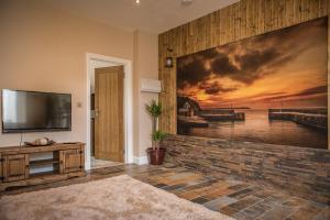 a living room with a wall mural of a pier at Deluxe Rustic Charlestown Themed Apartment in St Austell