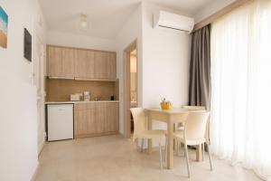 a kitchen and dining room with a table and chairs at Porfyris Studios and Apartments in Karpathos